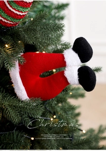 Detail of plush Christmas elf leg sticks used as festive ornaments for holiday trees