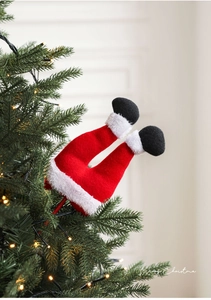 Close-up of Santa Claus leg picks decorated in a Christmas tree with warm LED lights