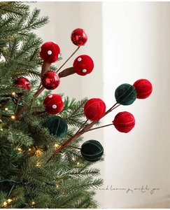 Detail of Christmas lollipop picks with red velvet, mirror balls and mushrooms on a tree