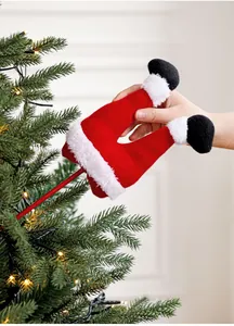 Detail of plush Santa legs branch picks inserted into a decorated Christmas tree