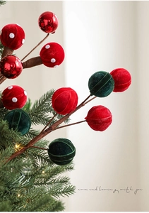 Close-up of festive Christmas picks with red and green flocked balls and polka dot ornaments