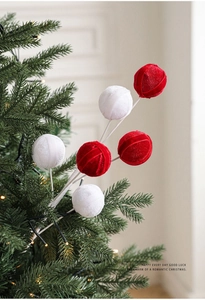 Detail of red and white velvet ball picks used as decorative ornaments for Christmas tree
