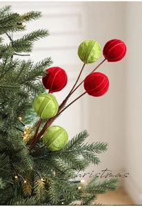Close-up of red and green velvet ball floral picks for Christmas tree decoration