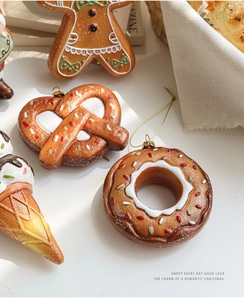 Detailed view of gingerbread man and dessert ornaments with glitter on a rustic background