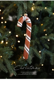 Macro shot of candy cane ornament with brown and white stripes and glitter texture