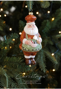 Detailed chef Santa Claus ornament with glitter on a Christmas tree with bokeh lights