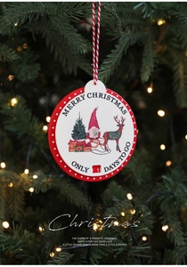 Close-up of wooden Christmas countdown plaque hanging on a decorated tree with festive lights