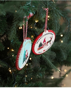Close-up of wooden Christmas countdown ornament with Santa and Reindeer on a festive tree