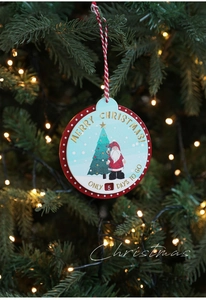 Macro detail of wooden Christmas countdown ornament hanging on a festive green pine tree