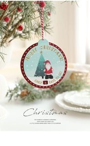 Detail of wooden Christmas countdown plaque featuring Santa Claus and pine tree graphics