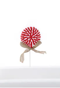Detail of red and white knitted candy cane ornament with a rustic burlap bow decoration