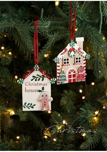 Detail of wooden Christmas house ornaments with gingerbread man and festive red strings