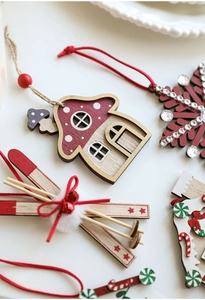 Close-up of red and white wooden Christmas ornaments with snowflake and mushroom motifs