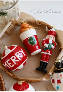 Flachbild von festlichem Weihnachtsschmuck mit Nussknacker und Merry-Anhängern im Korb