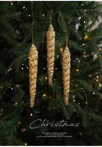 Detailed view of three gold glitter spiral icicle ornaments hanging on a Christmas tree