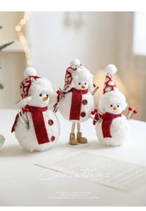 Three plush Christmas snowmen with red scarves and Nordic hats for festive table decor