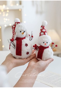 Close-up of plush Christmas snowmen set with red scarves for holiday table decor