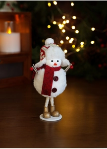 Detailed plush Christmas snowman figurine with red scarf and gold boots on a stand