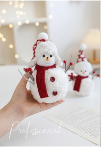 Detailed close-up of handmade plush snowman decor with red scarf and berry branch arms