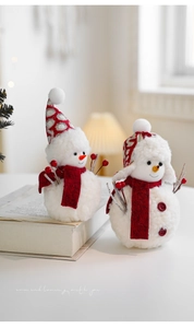 Detailed view of plush Christmas snowmen with red scarves and festive knitted hats