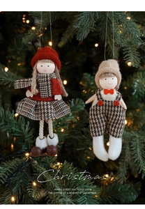 Christmas plush doll ornaments on tree with warm lights, featuring boy and girl styles