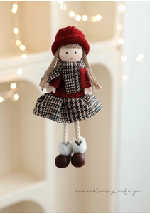 Detail of plush Christmas doll hanger with red knit hat and plaid scarf decoration