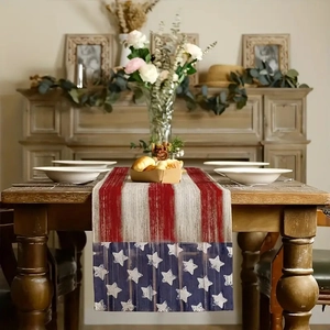Linen table runner with stars and stripes design on a dark wood table with home decor
