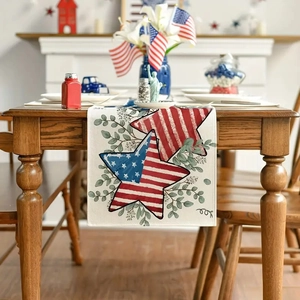 Detail of linen table runner with US flag stars and eucalyptus leaves on wooden table