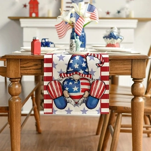 Detail of linen table runner with Independence Day gnome print on a wooden table