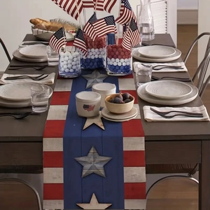 Detail of American flag linen table runner with red stripes and blue star wood texture