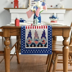 Detailed close-up of linen Independence Day table runner with festive gnome prints