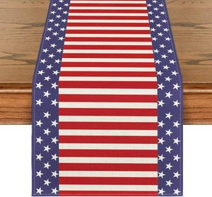 Detail of linen table runner with US flag patterns and neat stitched edges on wood