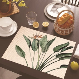 Close-up of tropical palm leaf placemat on wooden table with elegant breakfast decor