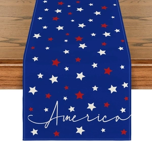 Macro shot of American Independence Day linen table runner with stars on wooden surface