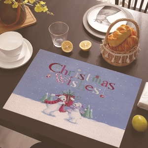 Christmas place mat with polar bears and wishes on dark wooden table with tableware