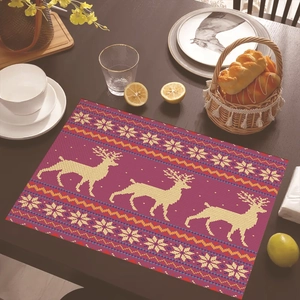 Close-up of a purple Christmas placemat with reindeer and snowflakes on a wooden table
