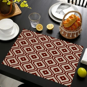 Detail of bohemian placemat with red and beige geometric wave patterns on wooden table