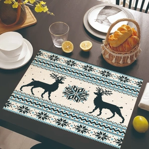 Close-up of a Nordic-style placemat with reindeer and snowflake patterns on wood