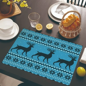 Close-up of sky blue Christmas placemat with reindeer patterns on dark wooden table