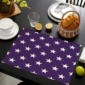 Deep purple star pattern table mat with dining accessories on a black wooden table