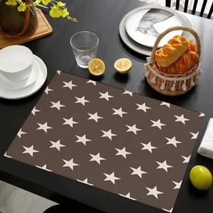 Detail of star pattern placemat on dining table with elegant home decor setting