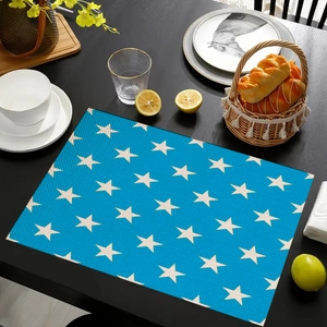 Rectangle blue placemat with white stars on a dark wood table with dining props