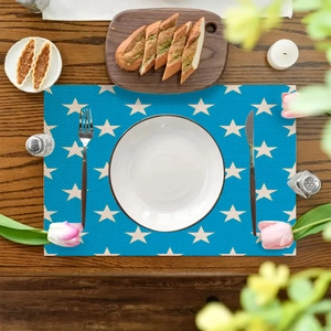 Navy blue star pattern rectangular placemat on a dark wooden table with dining decor