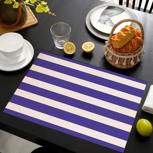 Blue and white horizontal striped linen placemat on a dark wooden dining table