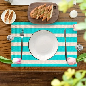 Striped linen textured non-slip placemat on a wooden table with elegant table setting