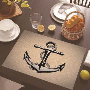 Close-up of nautical placemat with anchor design on a wooden dining table