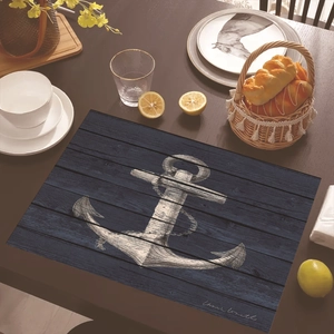 Close-up of nautical placemat with white anchor on blue wood grain for table decor