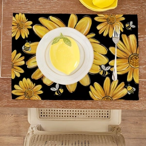 Detail of sunflower and bee pattern on rectangular woven placemat on a wooden table