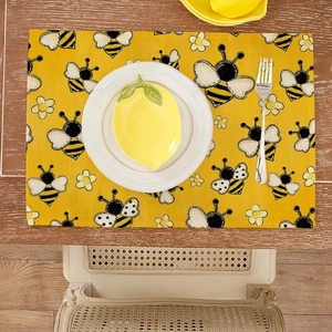 Yellow sunflower placemat with bee patterns on a rustic wooden table with tableware
