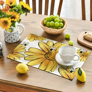 Close-up of sunflower and bee placemat on wooden table with elegant dining setup
